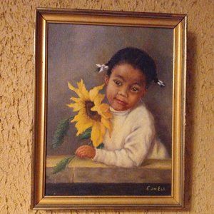 Young girl holding sunflower painting